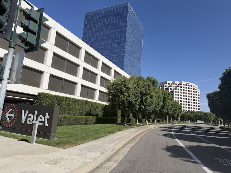 Office buildings near the Irvine Spectrum Center business district where Clarity Digital Agency is headquartered, with palm-lined streets under blue California skies