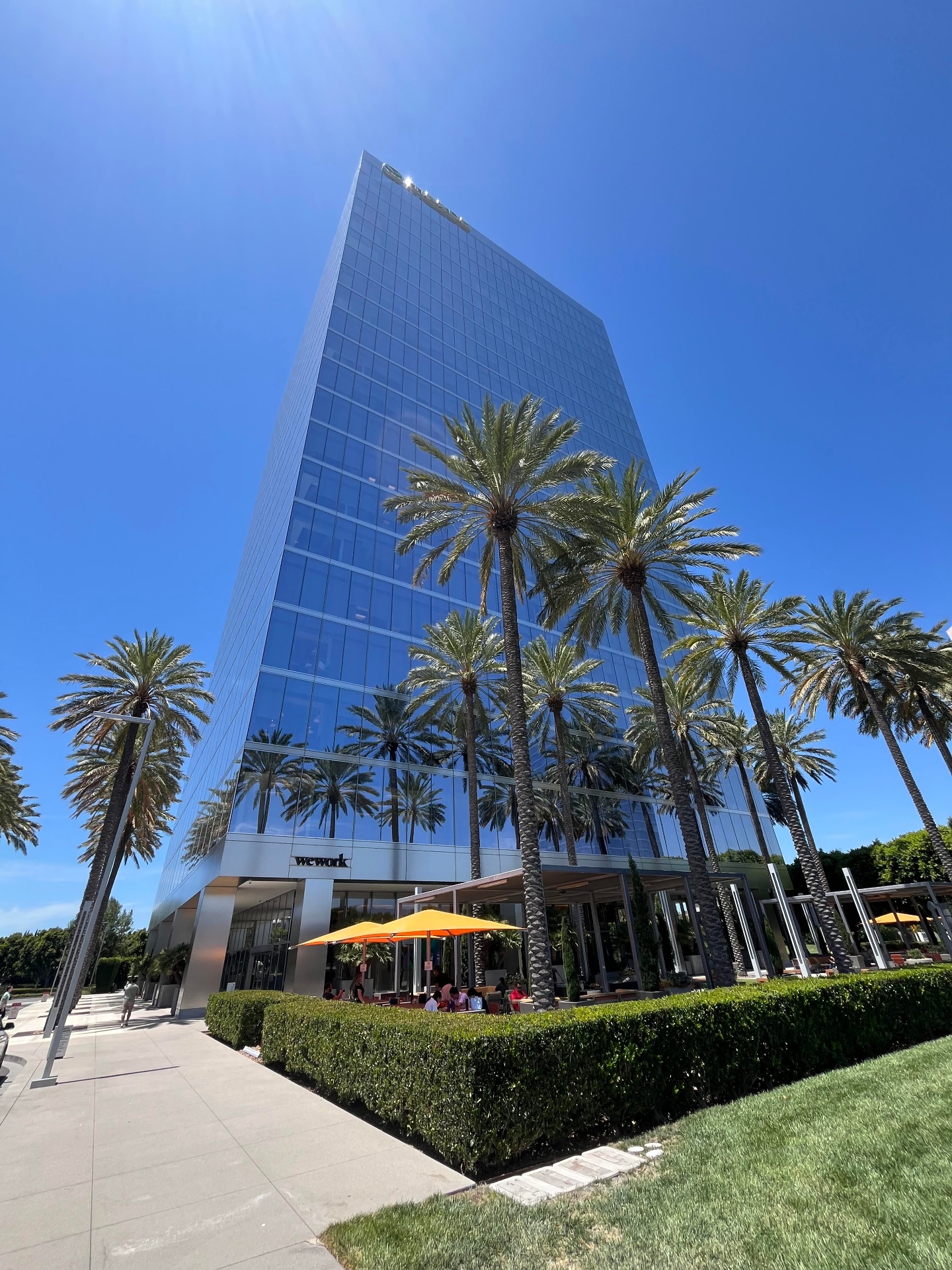 Clarity Digital Agency office building at 200 Spectrum Center Dr, Irvine — home to Mazda, Salesforce, and WeWork, surrounded by palm trees